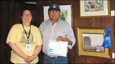 Bill Cloutman receiving award at Painting the Town Reception.